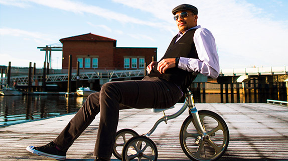 Man sitting in tricycle. Concept by Gold Dog Communications for Twelve12.